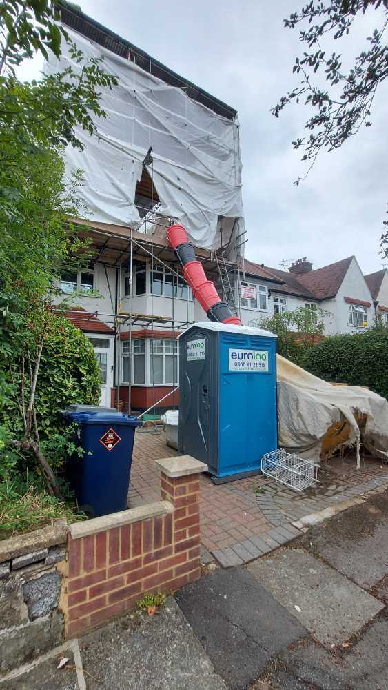 euroloo outside a home with builders chute