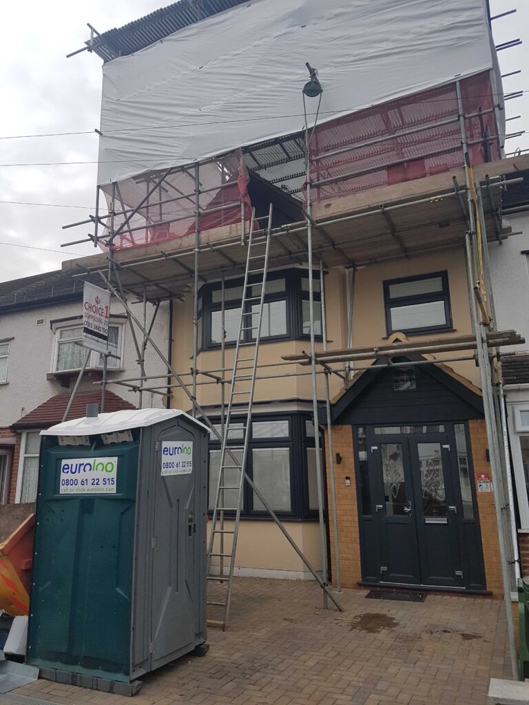 euroloo outside home with scaffolding