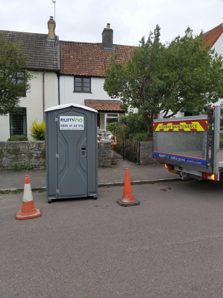 euroloo outside house with cones