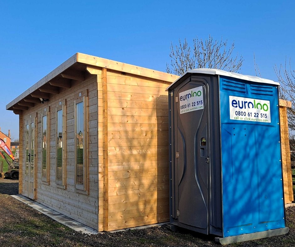 Euroloo Welfare Unit Positioned Beside A Newly Built Timber Shed On An Active Construction Site.